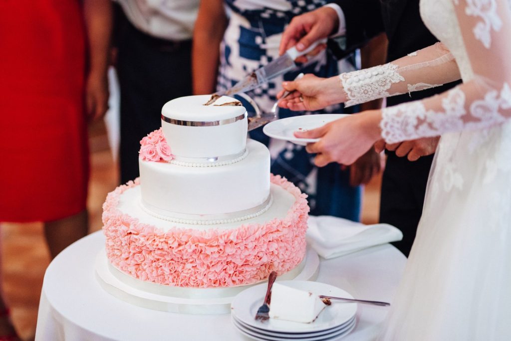 newlyweds happily cut and taste the wedding cake.jpg